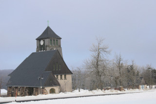 Na okraji Zinnwaldu se těsně za hranicí tyčí luteránský kostel. Ačkoli svatyně je až z roku 1909, tak se řadí mezi Exulantenkirche. Ty původně zakládali protestanti, kteří z Čech uprchli za rekatolizace a osídlili německou stranu Cínovce i okolí Altenbergu. U Zinnwaldu založili exulantskou kolonii.